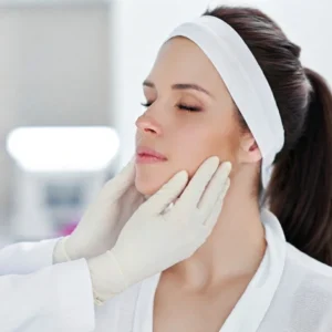 Facial Balancing Assessment by Master Injector at Simple Radiance Medspa Austin - SimpleRadianceMedSpa - SimpleRadianceMedSpa Close-up of a female patient receiving a detailed facial assessment by a practitioner in white gloves at Simple Radiance Medspa in Austin, TX.
